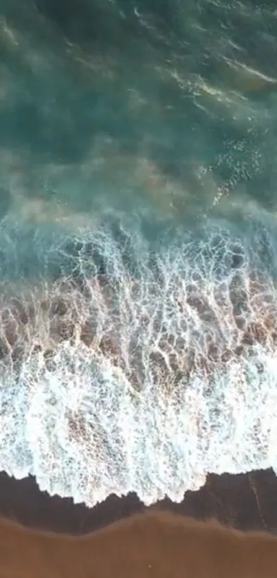 Aerial ocean view with turquoise waves and sandy beach.