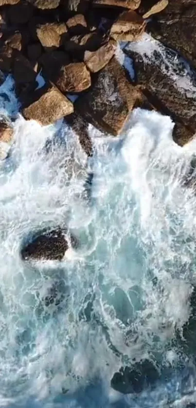 Aerial view of ocean waves crashing on rocky shore.