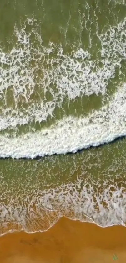 Aerial view of ocean waves on a sandy shore, perfect for mobile wallpaper.