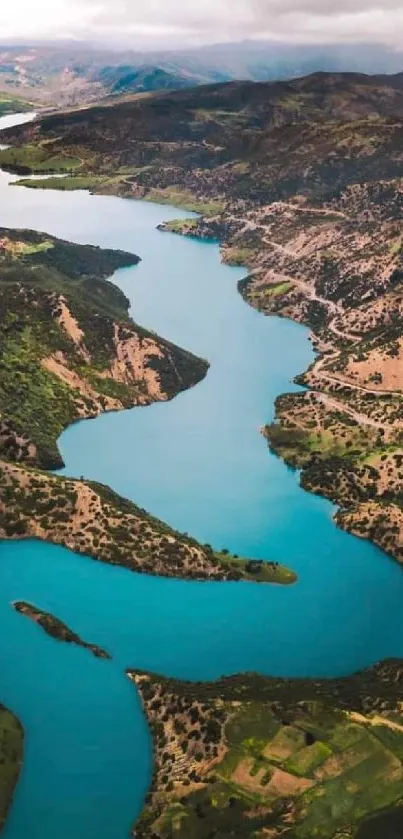 Aerial photo of a winding river in mountainous terrain with vibrant blue water.