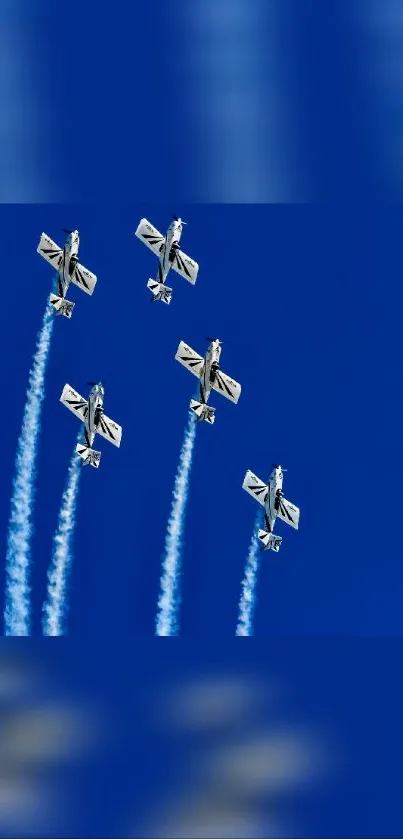 Aerobatic planes flying in formation against clear blue sky.