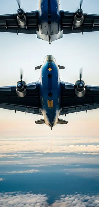 Two aircraft flying over clouds in a blue sky.
