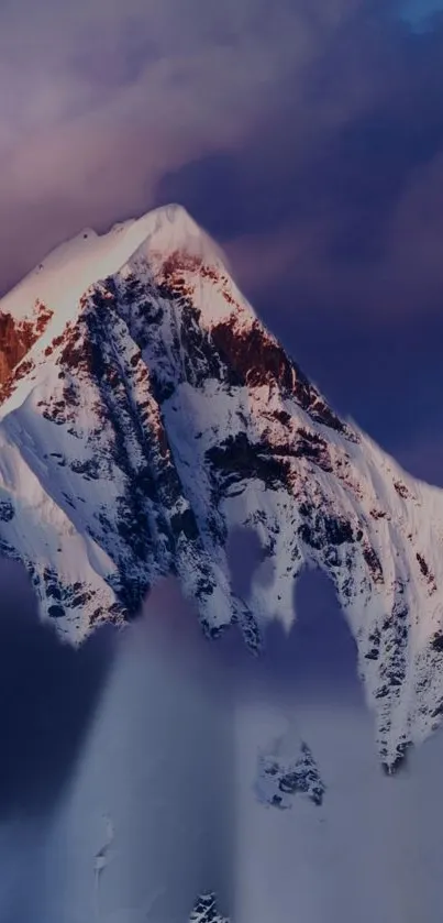 Snow-capped mountain under a twilight sky with purple and blue hues.