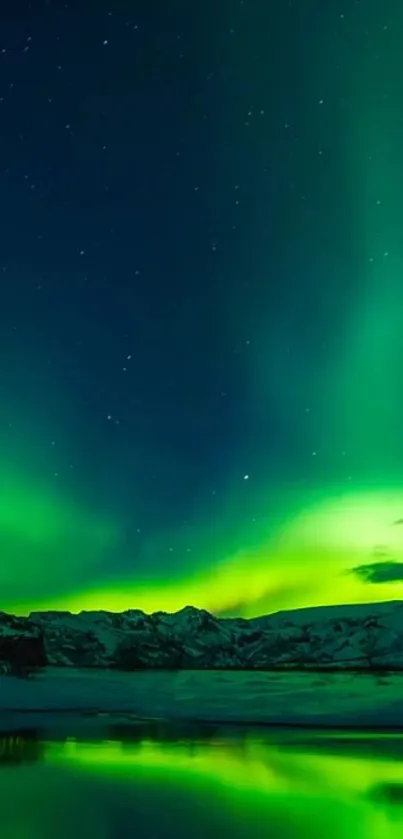 Vibrant aurora borealis over snowy mountains and reflective water.