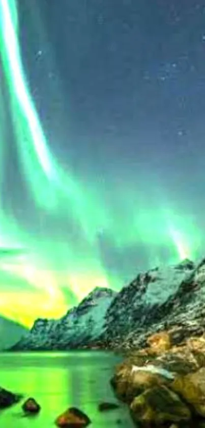 Aurora Borealis over snowy mountains at night with vibrant green sky.