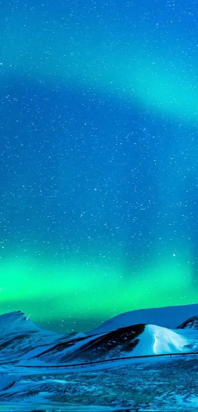 Aurora Borealis glowing over snowy mountains under a starry night sky.