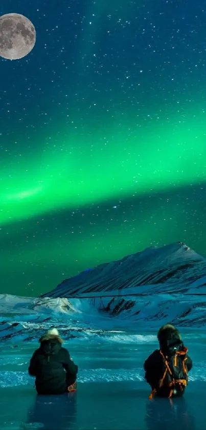 Aurora borealis over snowy landscape with two people under moonlit sky.