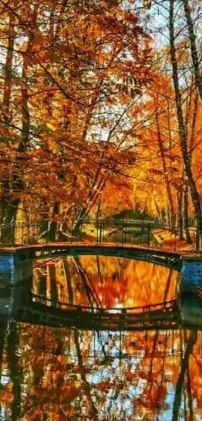 Autumn bridge surrounded by vibrant orange leaves and a reflective river.