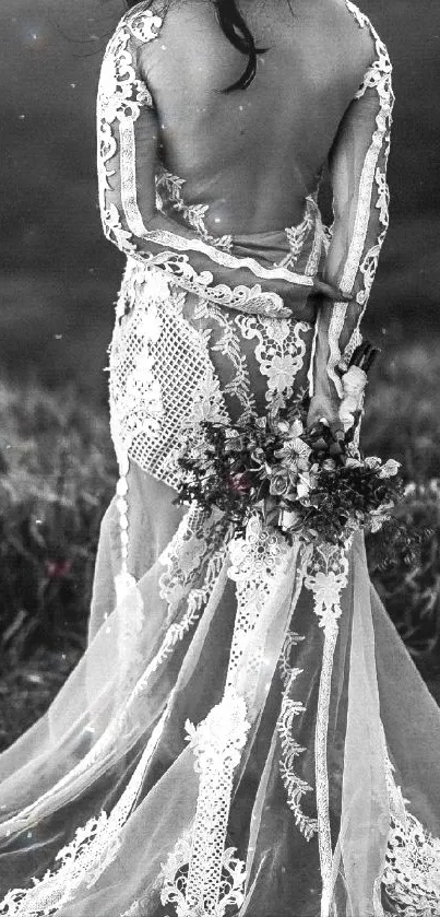 Elegant bride in a backless gown stands against a scenic backdrop in black and white.