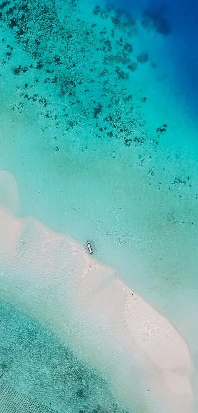 Aerial view of turquoise beach with pristine sand and clear blue ocean.