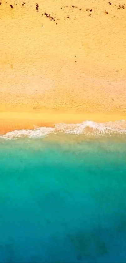 Aerial view of beach with turquoise ocean and golden sand.