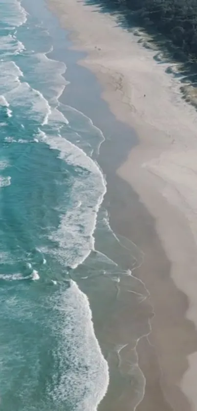 Aerial view of a beach with turquoise waves and a sandy shoreline.