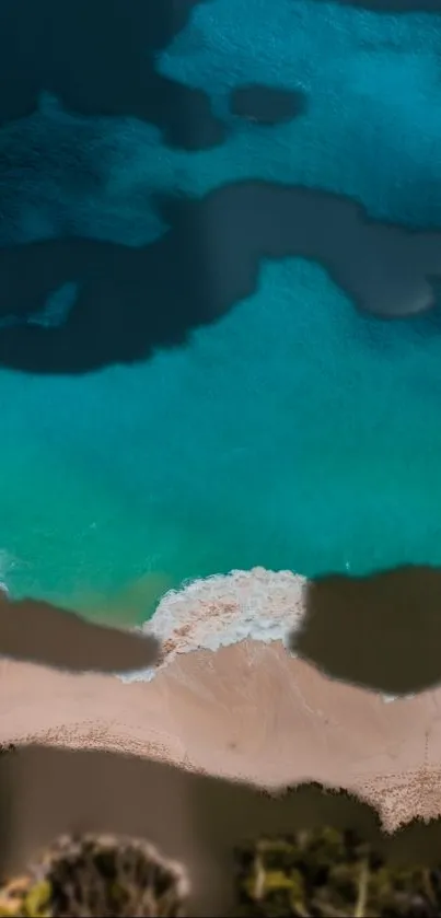 Aerial view of a turquoise ocean meeting a sandy beach.