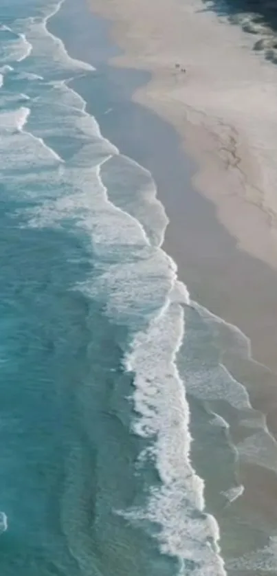 Aerial view of a beach with teal ocean waves and sandy shores.