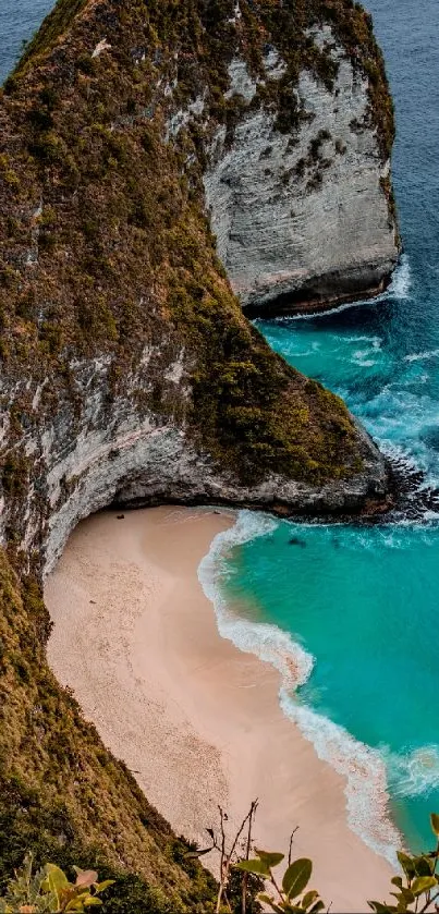 A breathtaking view of a beach with a towering cliff and turquoise waters.