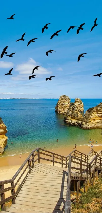 Beach cliffs and ocean view with blue skies and a wooden path leading to the sand.