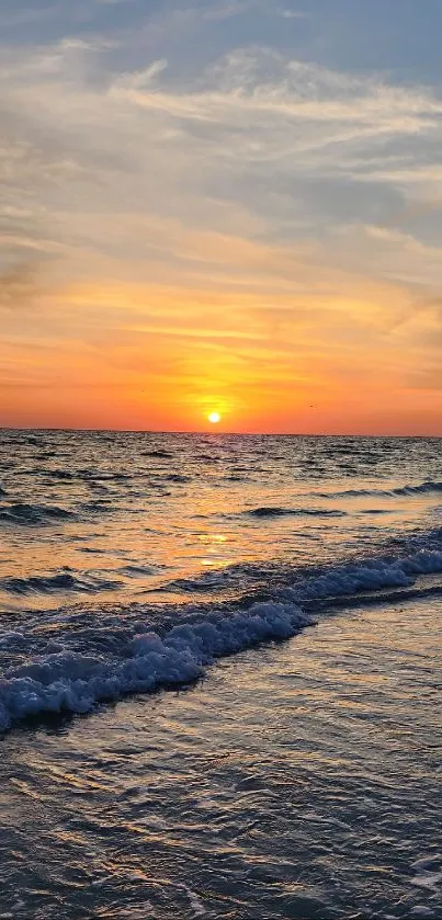 Glorious sunset over a calm ocean with vivid, warm colors on the horizon.