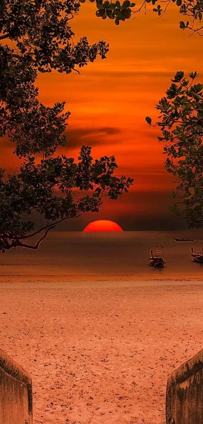 Vibrant orange sunset over a tranquil beach with boats on the horizon.