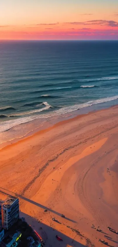 Beautiful beach sunset with waves and vibrant colors on the horizon.