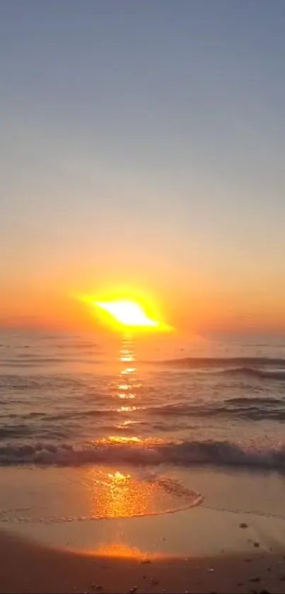 Mobile wallpaper of a stunning beach sunset with orange and blue tones over the ocean.