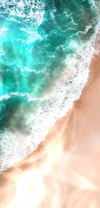 Aerial view of turquoise ocean waves meeting sandy beach, creating a serene wallpaper.