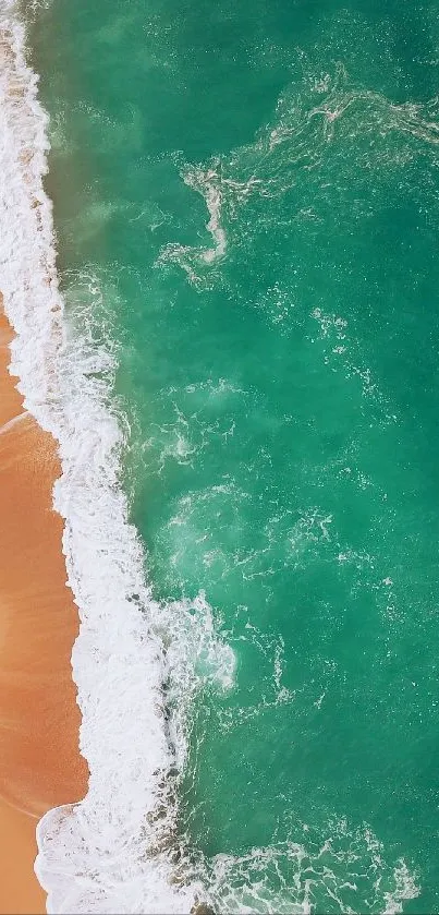 Aerial view of crashing waves on a sandy beach.