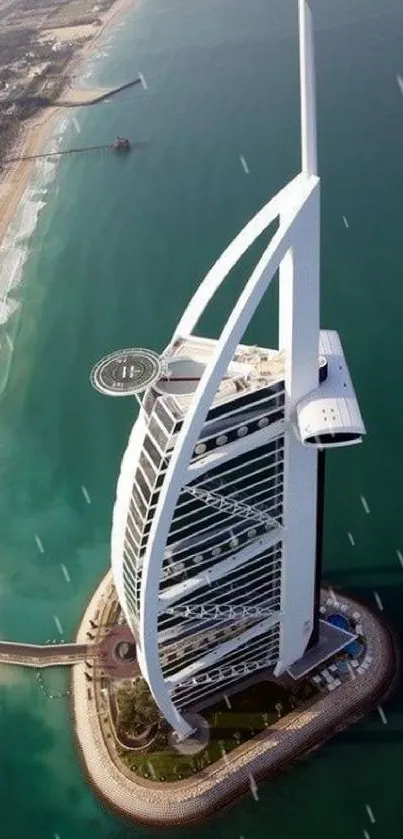 Aerial view of a beachfront skyscraper surrounded by ocean and sand.