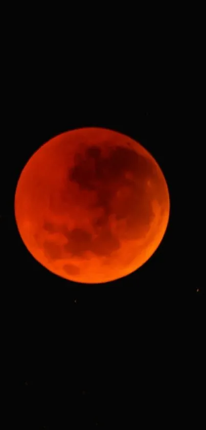 Red-orange blood moon in a dark sky wallpaper.