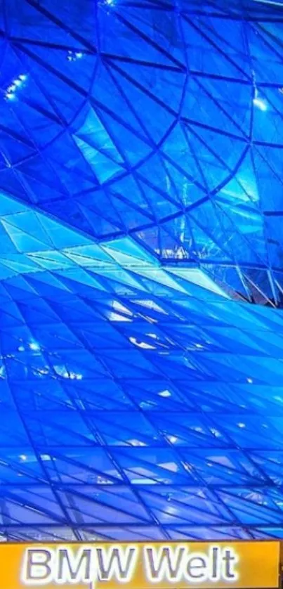 Futuristic blue glass architecture of BMW Welt at night.