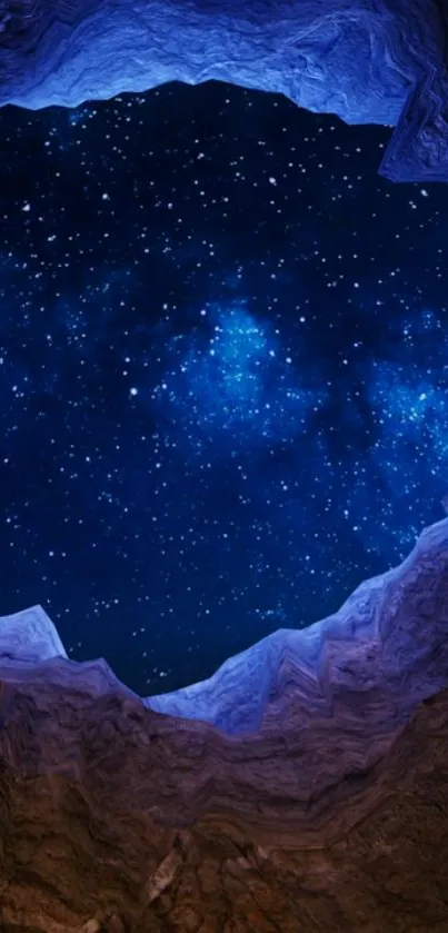 Star-filled blue night sky framed by rocky canyon walls.