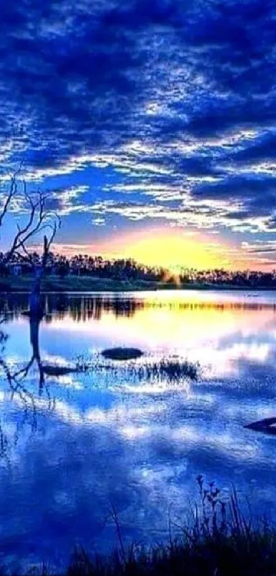 Blue sunset reflecting over a tranquil lake with vibrant clouds.