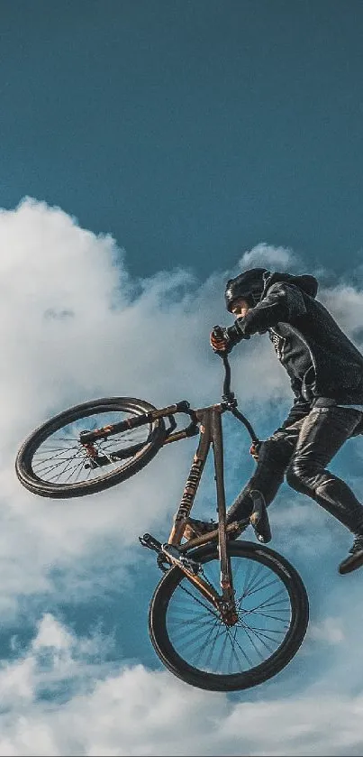 BMX biker performing a stunt mid-air against a vibrant cloudy sky.
