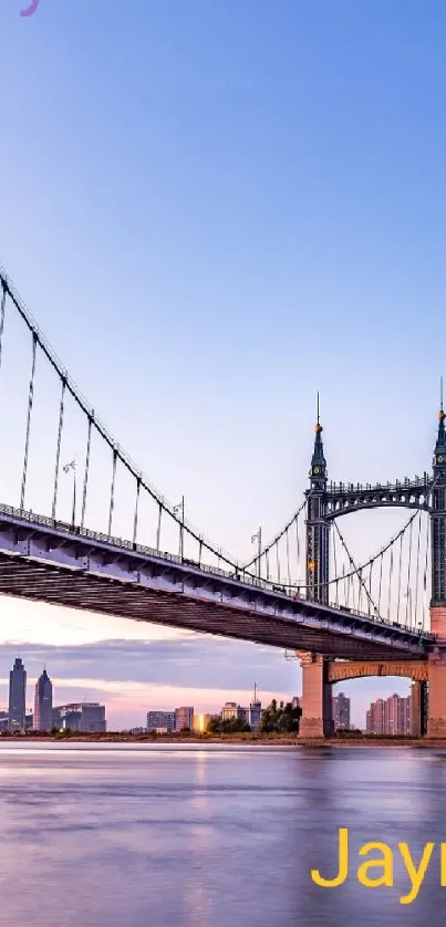 Elegant sunset bridge reflecting on water in a serene cityscape.