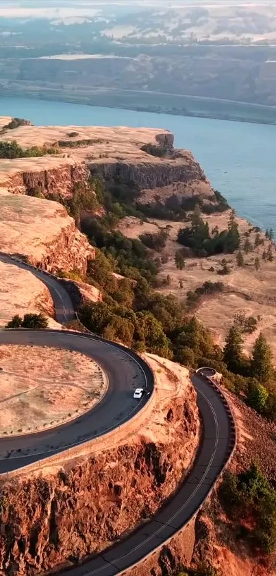 Winding road through a scenic rocky canyon with a river view.