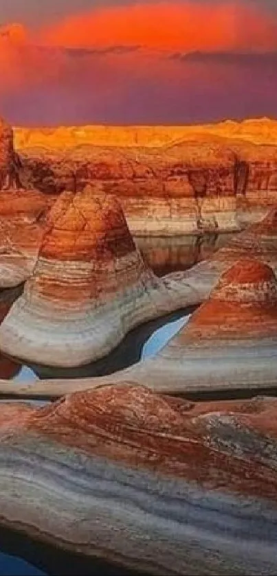 Stunning canyon landscape at sunset with vibrant orange and red hues.