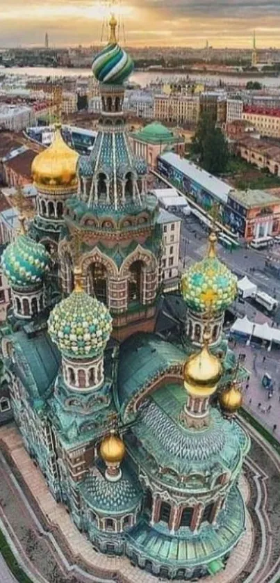 Aerial view of a historic cathedral with golden domes against a city skyline.