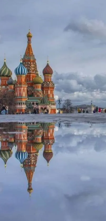 Mobile wallpaper of a colorful cathedral reflecting on water under a serene sky.