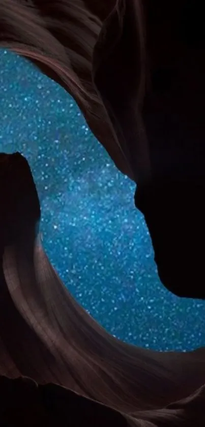 Galaxy-like night sky seen through rocky cave silhouette.