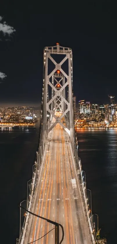 Night view of illuminated city bridge stretching across the water.