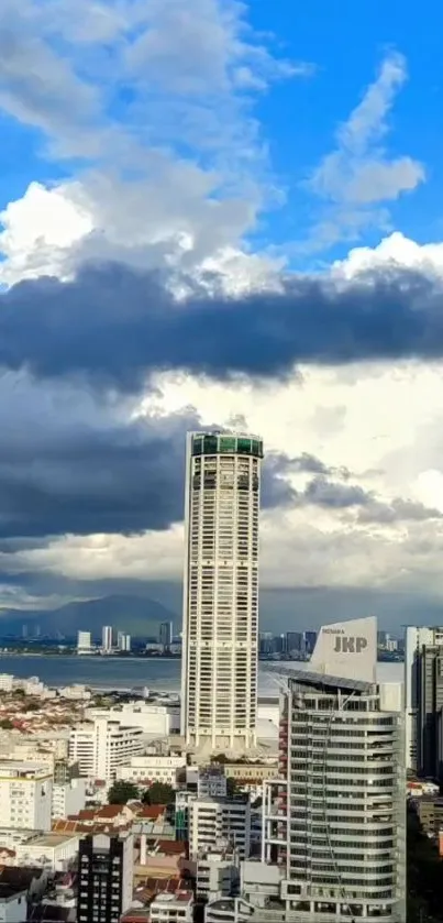 Panoramic view of a modern city skyline against a bright blue sky with clouds.