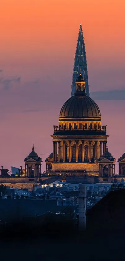 Majestic cityscape with spire at sunset displaying vibrant orange sky hues.