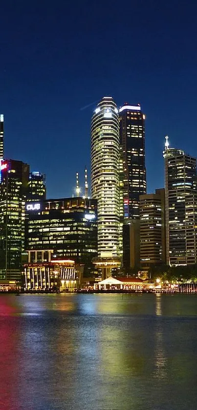 Vibrant night view of a cityscape with reflections over a tranquil river.