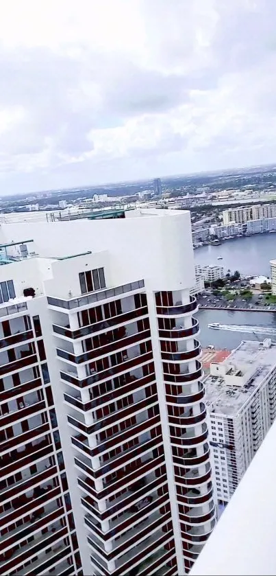 Tall skyscraper cityscape view with river backdrop.