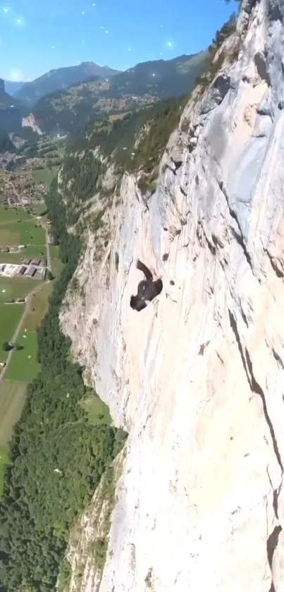 Man climbing a majestic cliffside with scenic mountain view.