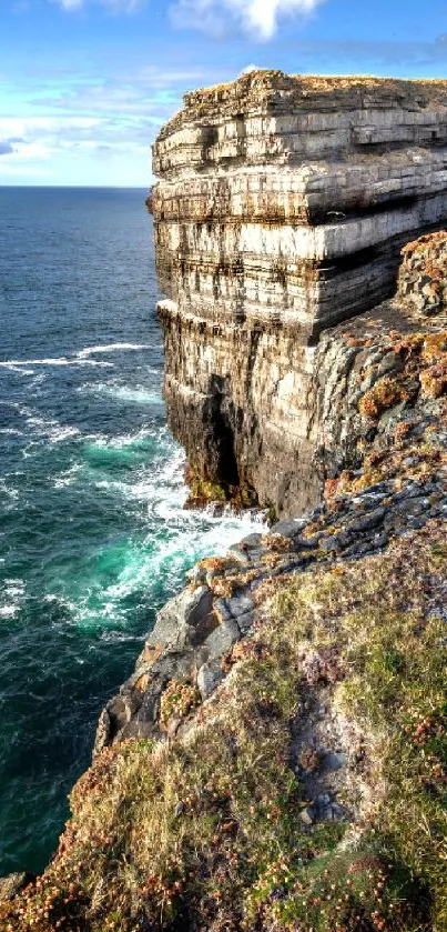 Cliffside ocean view with vibrant blue sea and sky.