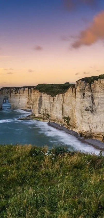 Sunset over majestic cliffs and ocean waves.