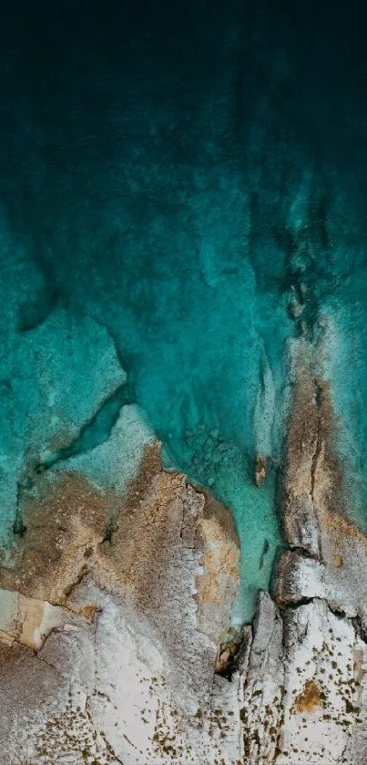 Aerial view of turquoise blue ocean and rugged coastline.