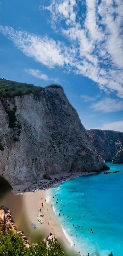 Cliffside beach with turquoise waters and blue sky.