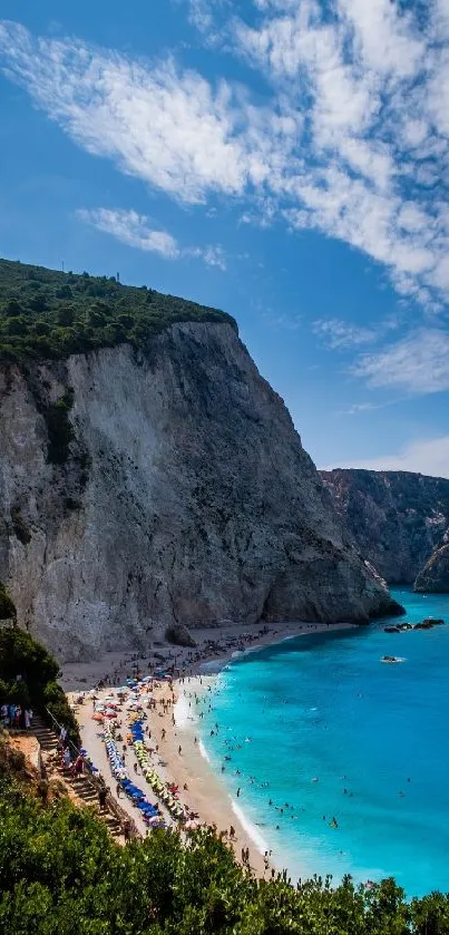 A picturesque view of azure waters beside a dramatic cliffside beach, under a clear blue sky.