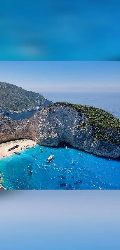 Beach with blue ocean and cliffs under a clear sky.